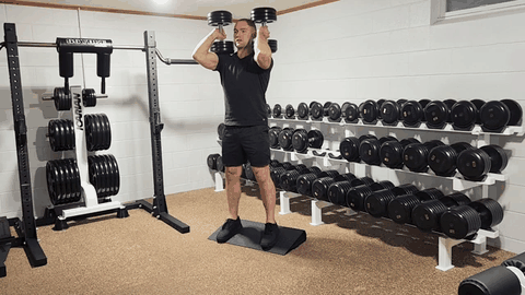 Heels-elevated double-dumbbell front squat demonstration